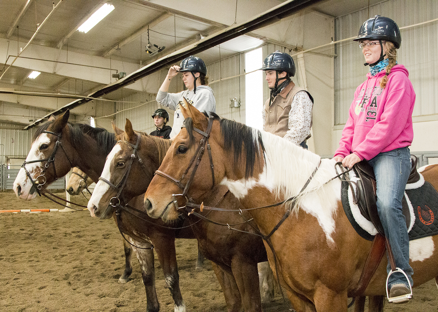 Students on their horses in the equine center 