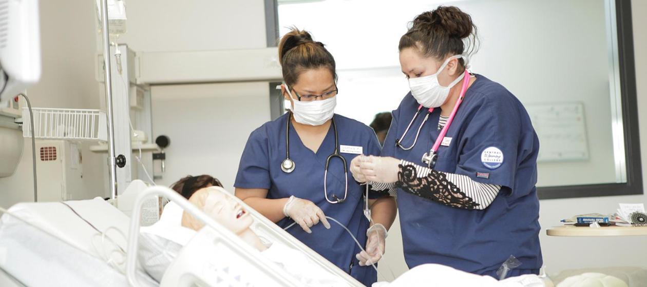Two students work in the nursing simulation lab