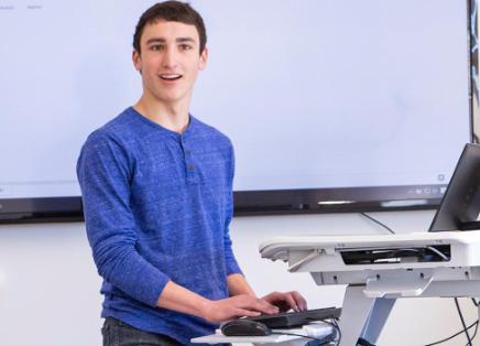 Dayne Bradley stands at a computer