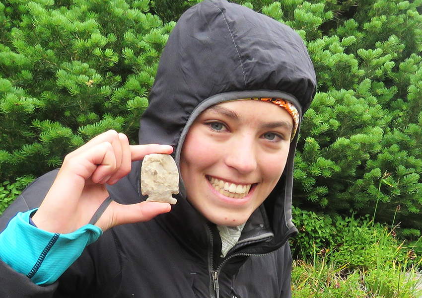 CWC student hold a part of a spear head found near the Dinwoody Glacier