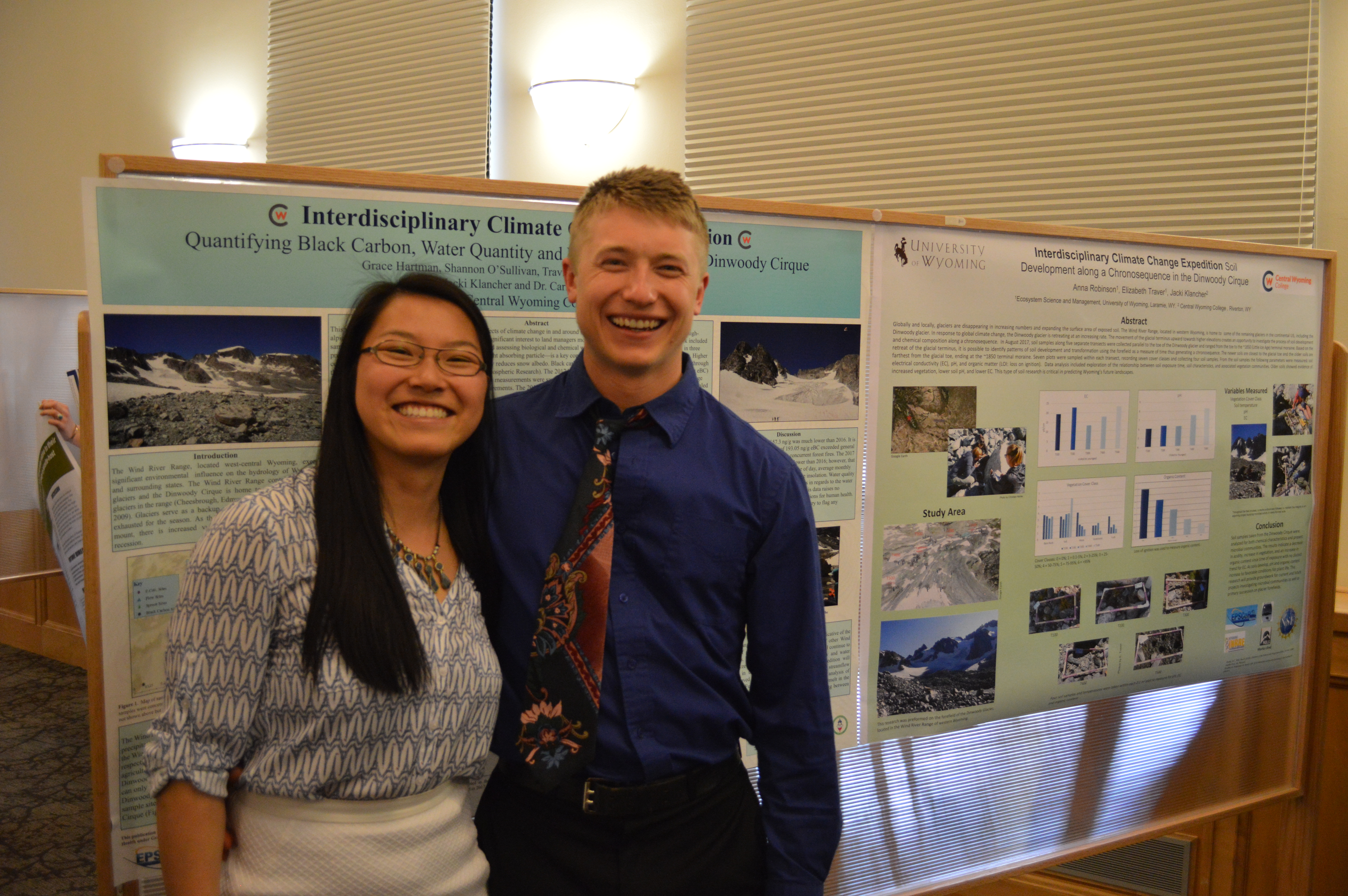 CWC alumni Grace Hartman and Marten Baur pose in front of their presentation poster for their research on linking science to contemporary issues facing greater societies at the University of Wyoming's Undergraduate Research Day