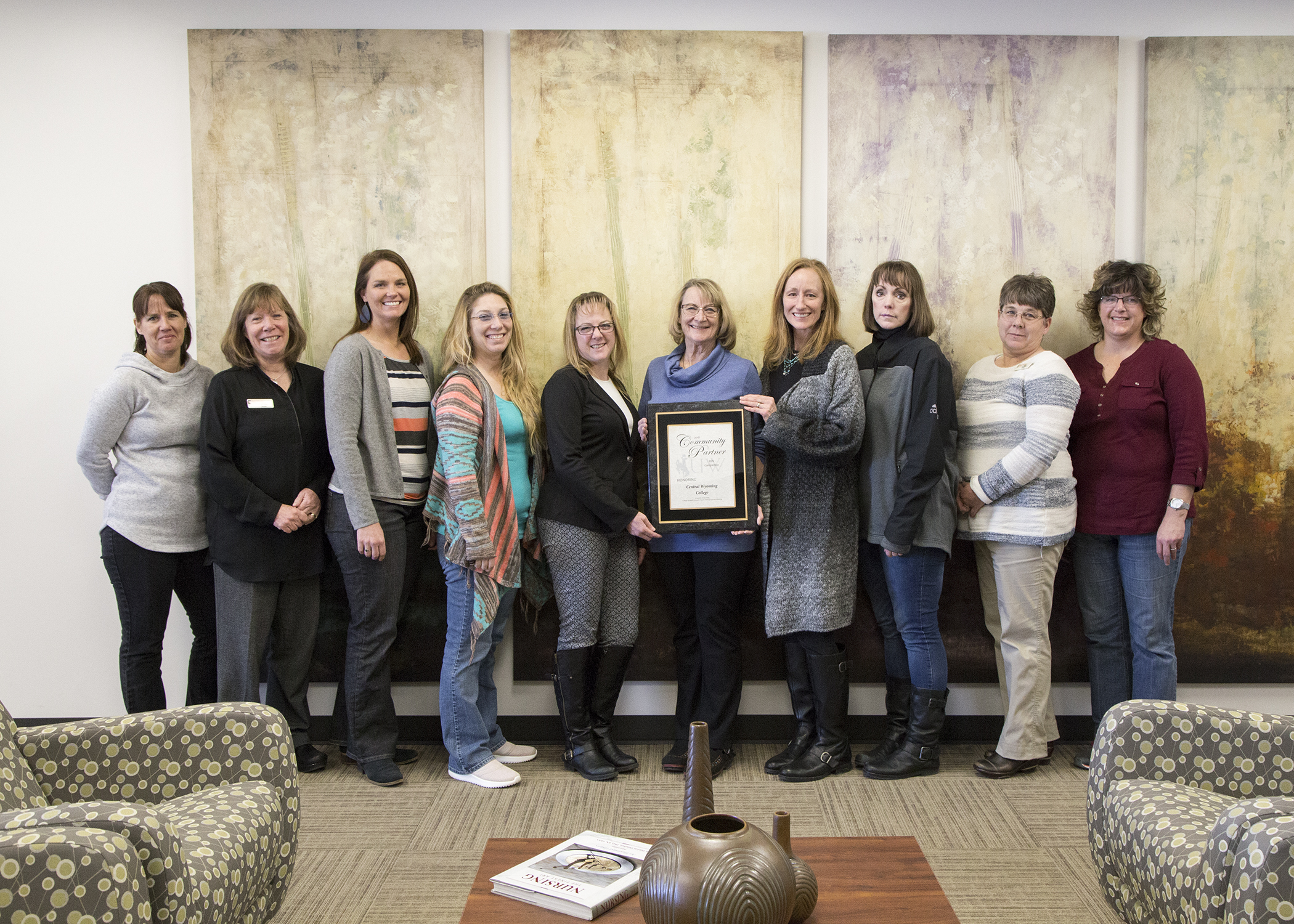 The CWC nursing staff stands holding an award from UW