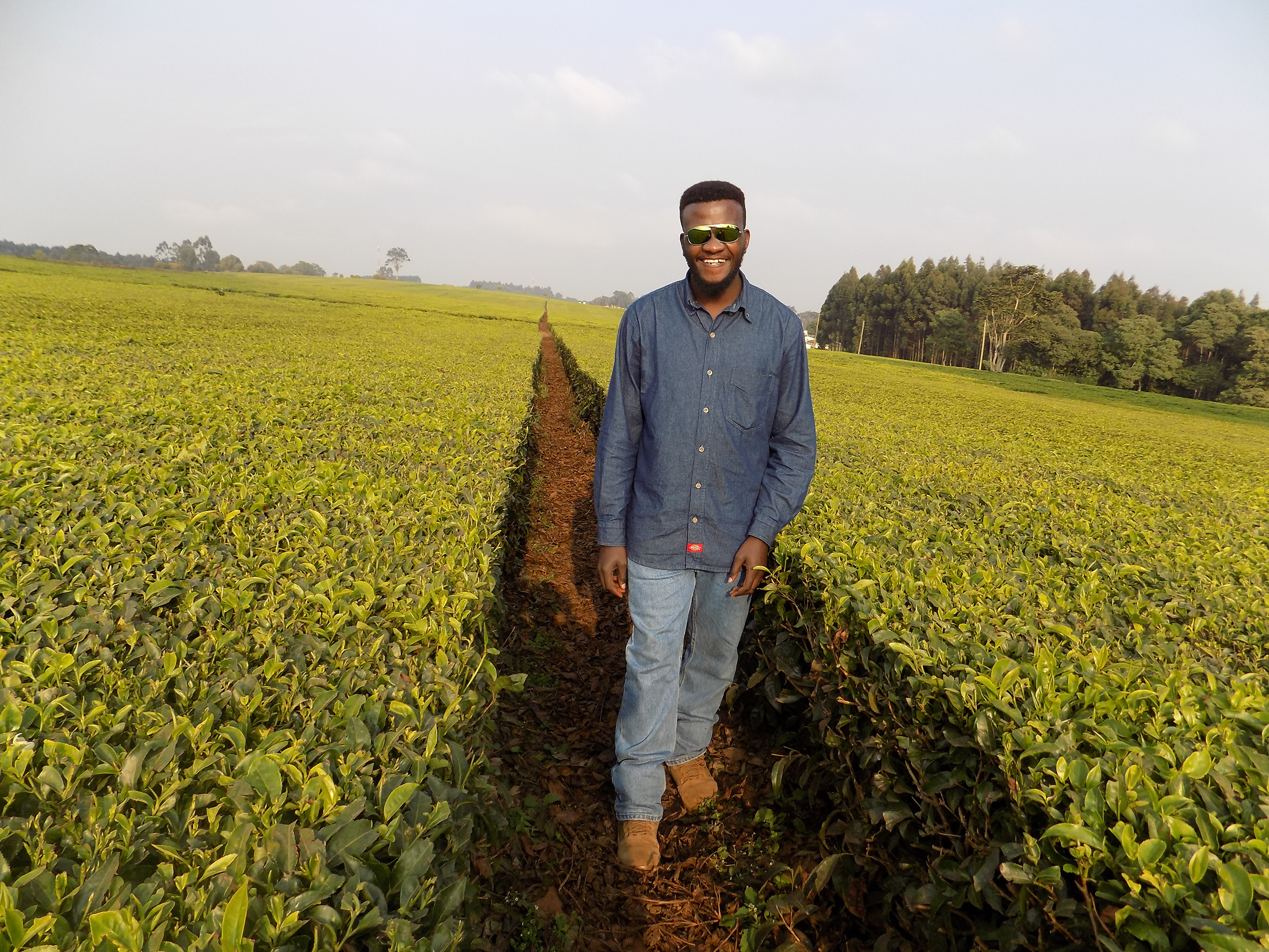 portrait of CWC student Brian Mwangi in a field