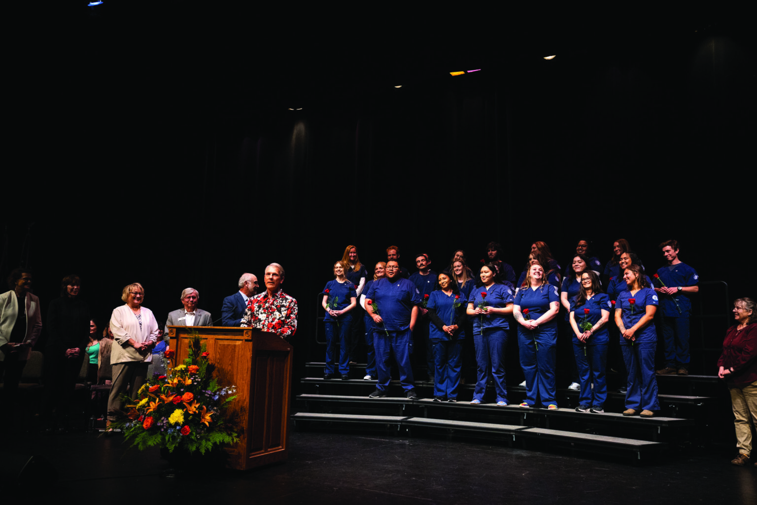 Nursing Students in front of a black curtain at the Pinning
