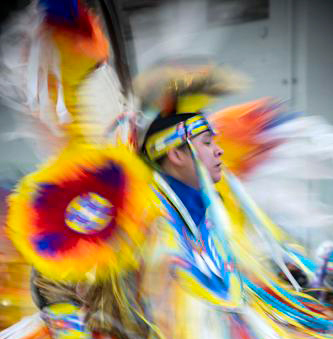 A Native American Dancer in full regala dancing at a powwow