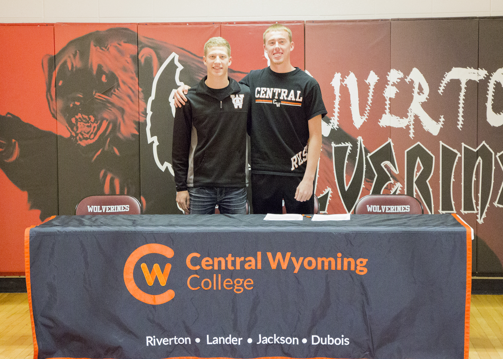 photo of high school men basketball players signing a letter of intent with Central Wyoming College