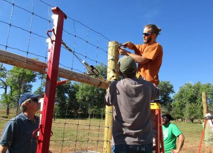 Volunteers building new orchard fence.