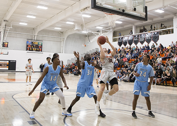 A Rustler going for a close shot at a men's basketball game