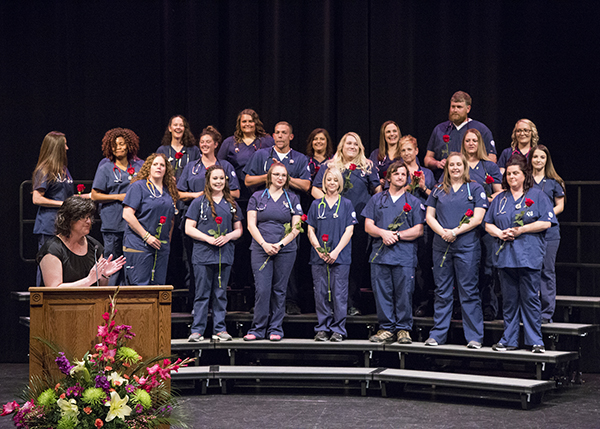 CWC nursing student on stage for pinning ceremony