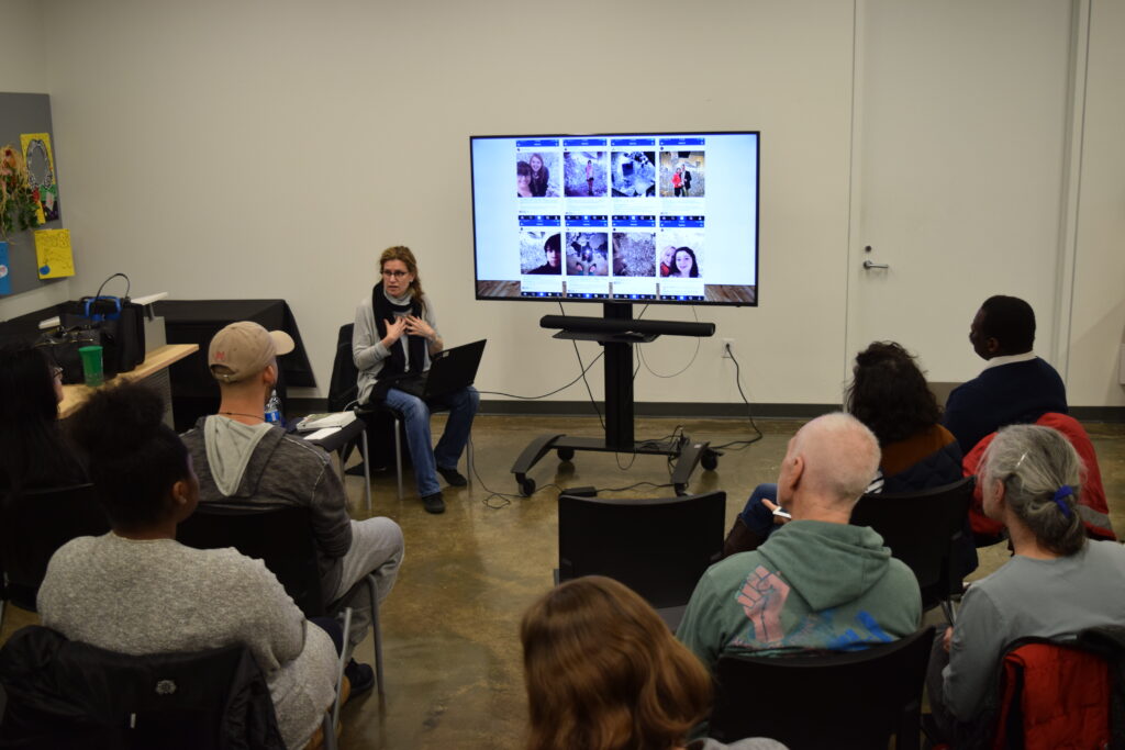 artist Sharon Louden presents to a group of people