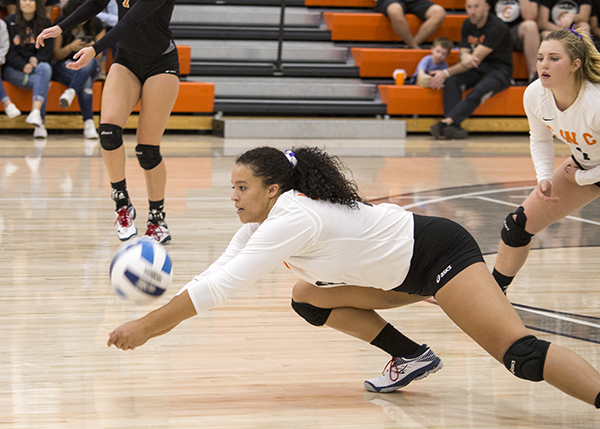 CWC volleyball player dives for the ball.