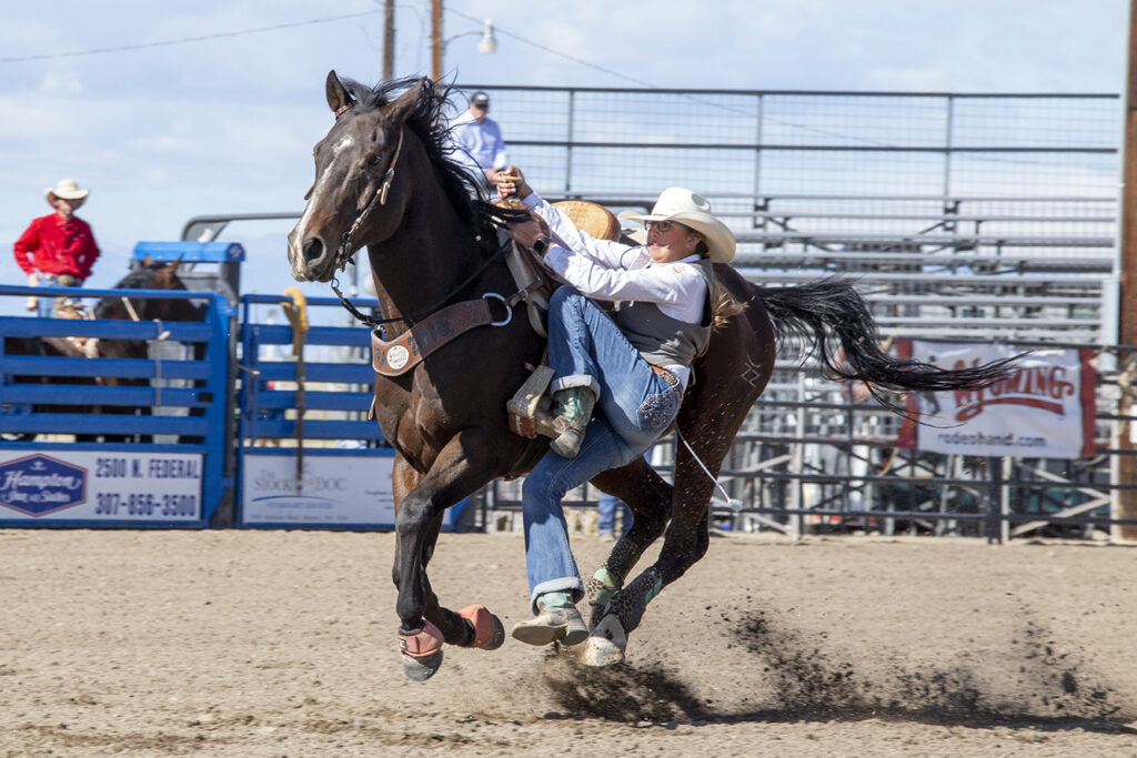 CWC rodeo cowgirl slides off her horse that is running