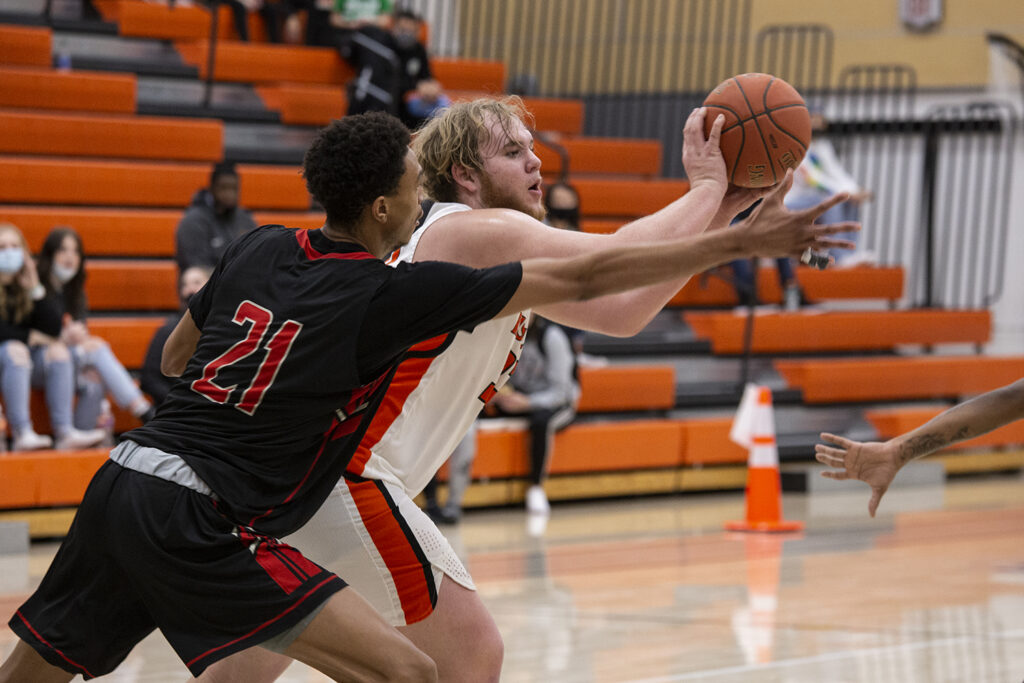 CWC men's basketball player grabs the basketball