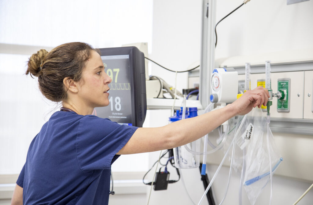 A CWC nursing student hangs a medical bag