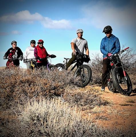 five students pose on their bicycles