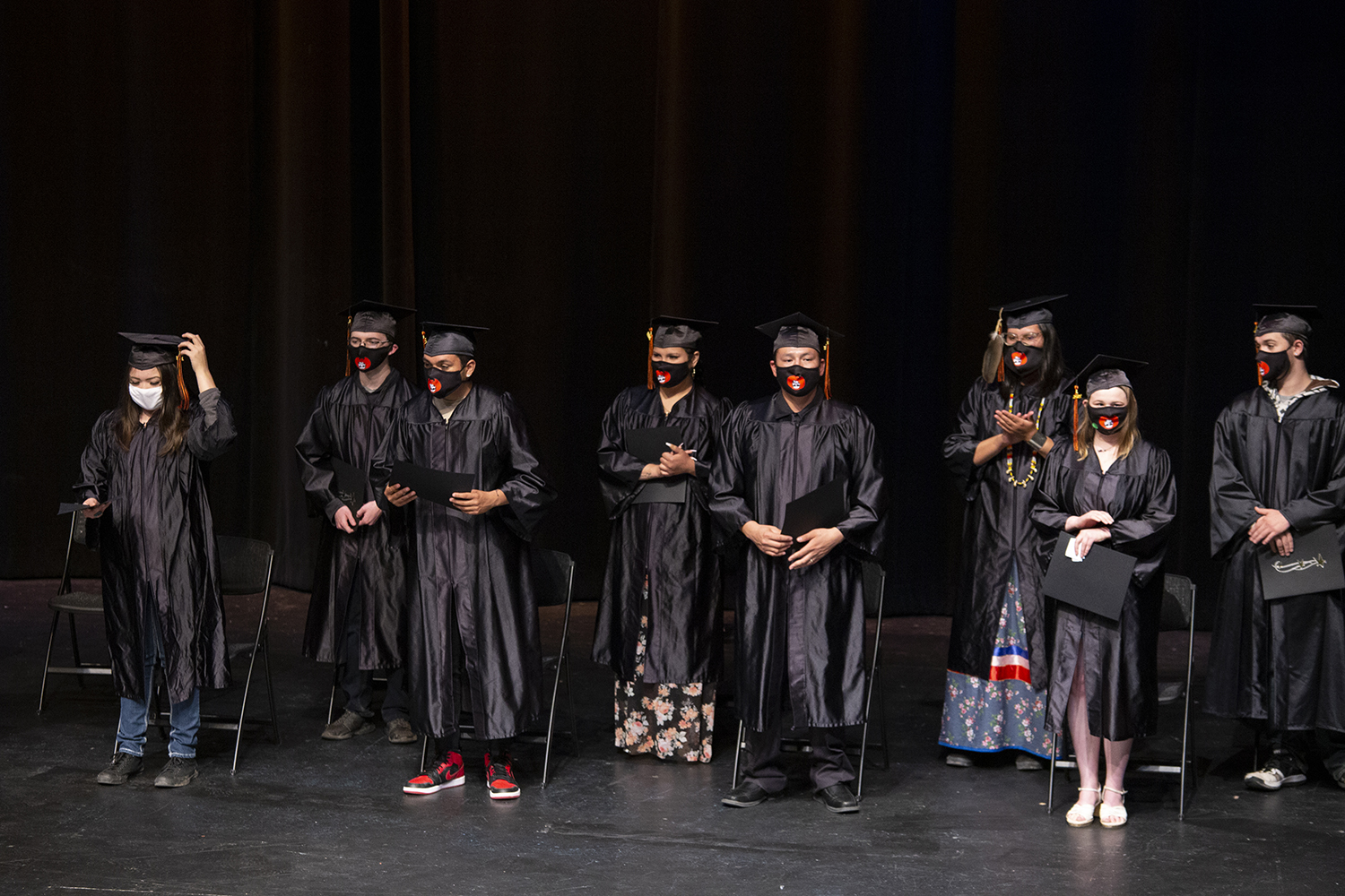 students who graduated with their high school diploma stand on stage