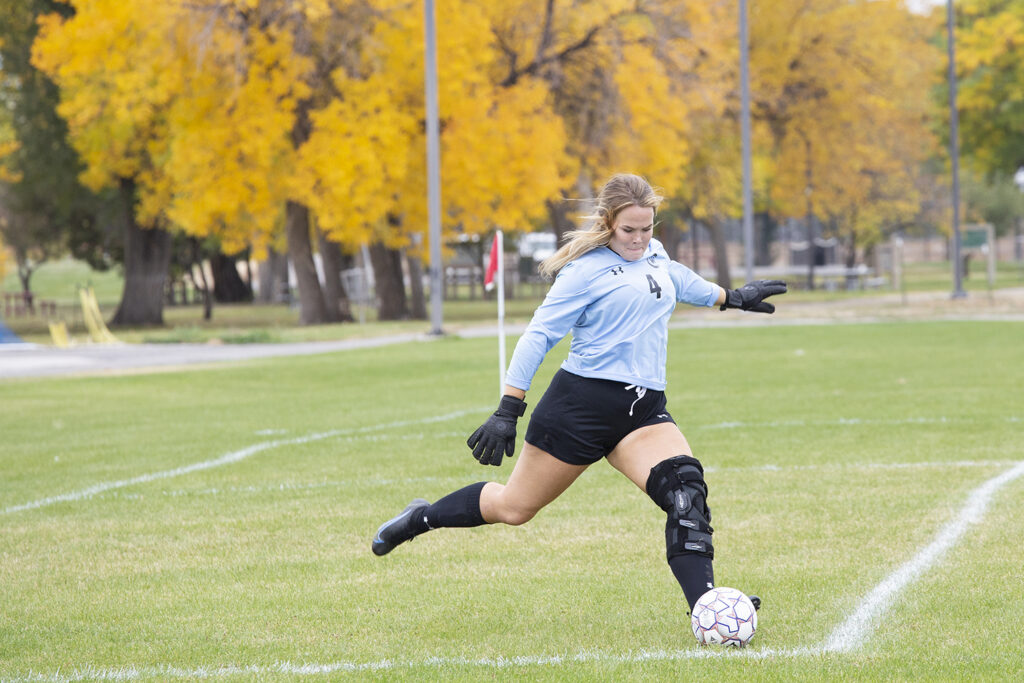 Goalie of the CWC women's soccer team kicks the ball