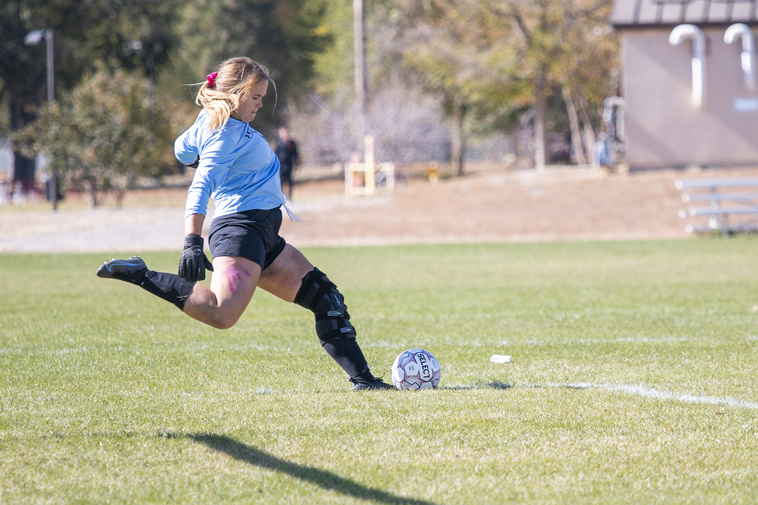 CWC's women's goalie kicks the soccer ball