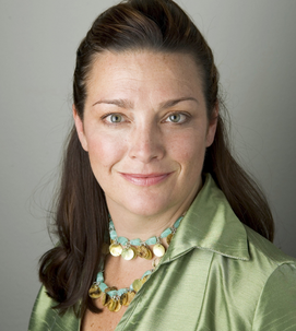 A headshot of Jennifer Marshall. She is wearing a green jacket and has brown hair.