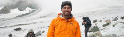 A student in an orange jacket surveys the Dinwood Glacier.