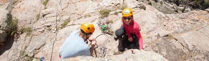 Two students rock climb in sinks canyon state park