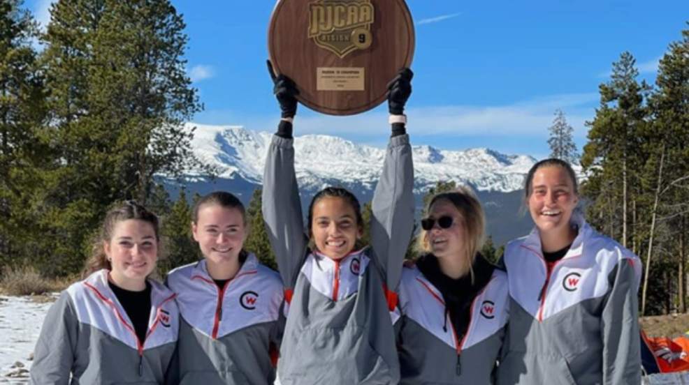 American Indian Athlets holding up a trophy from the NJCAA