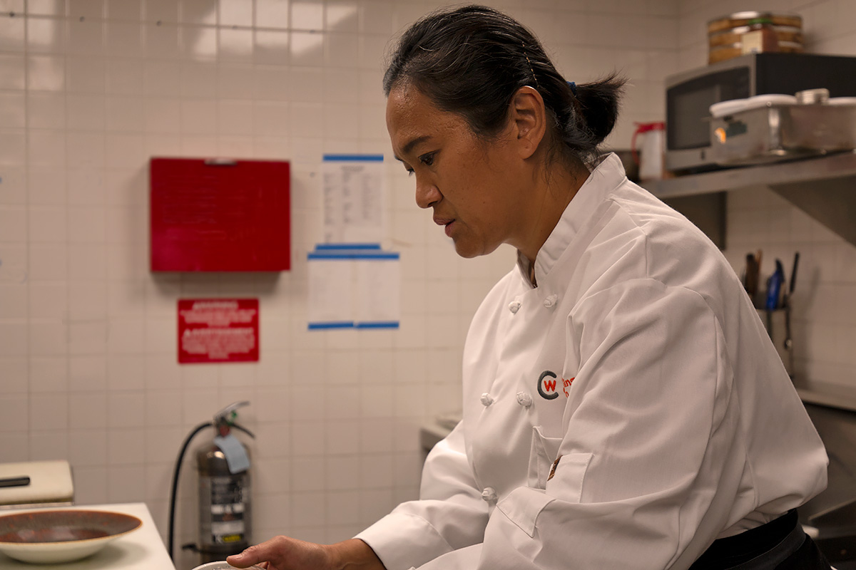 Picture of Culinary student Stephanie Roche preparing food