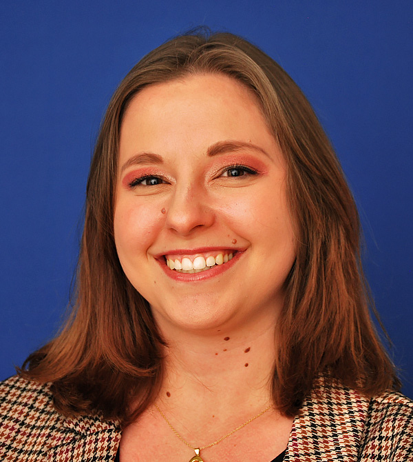 A headshot of Angel Jahnke. She has brown hair, brown eyes, and fair skin