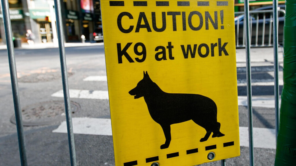image of a sign that says Caution K9 at work with a graphic of a dog