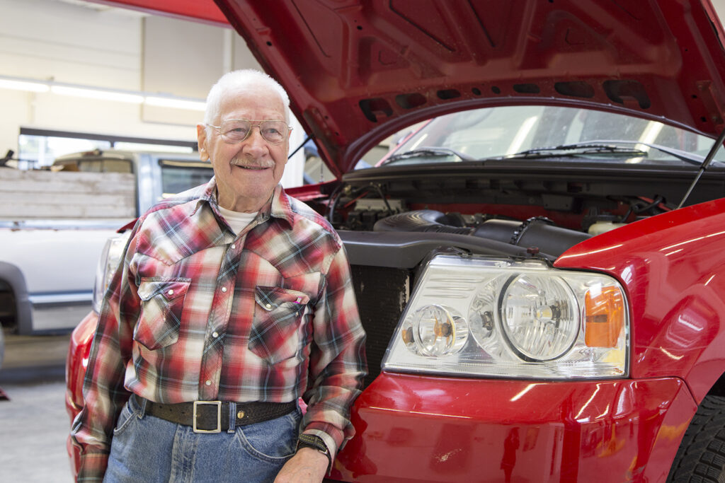 photo of student Ray Snyder next to a red truck