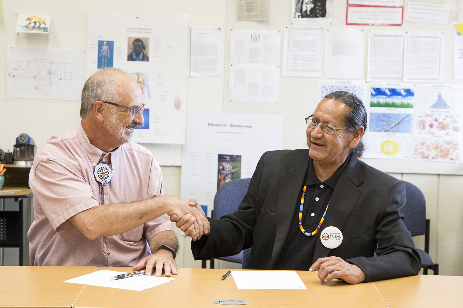 photo of Dr. Brad Tyndall and Marlin Spoonhunter shaking hands