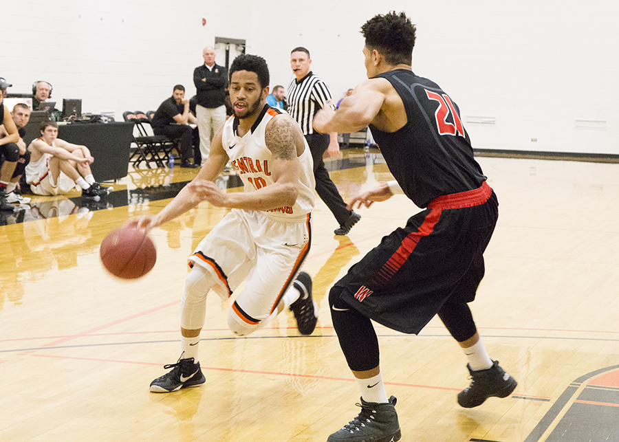 CWC basketball player dribbles ball past Western Wyoming Community College player