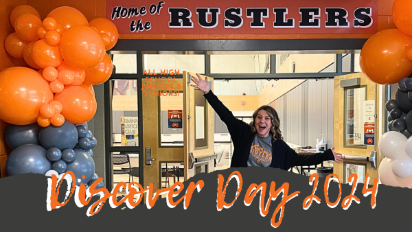 Rachel Hofer, Director of Admissions, standing in front of sign that says Home of the Rustlers