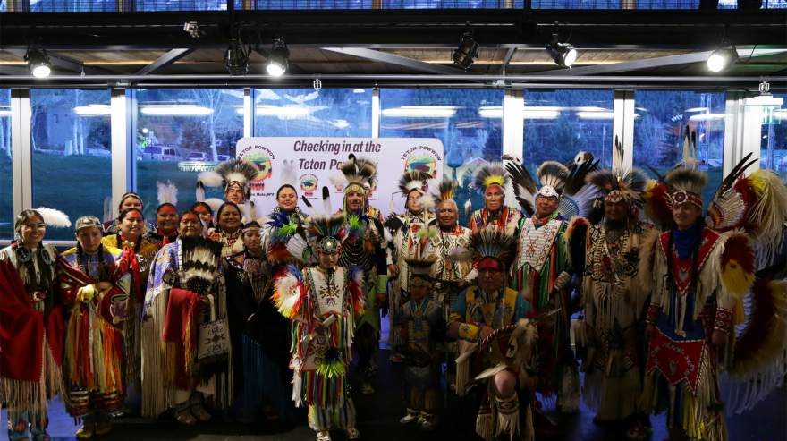 Powwow dancers stand in traditional regalia at the opening night of the Teton Powwow in Jackson in 2022.